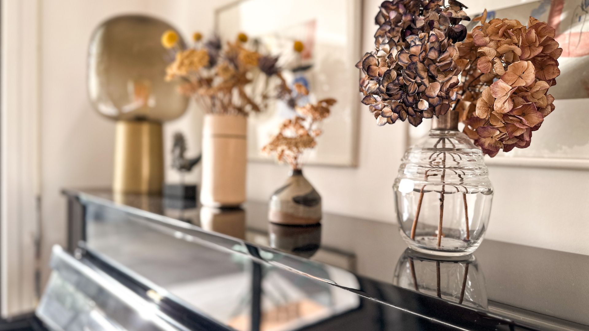 A vase of flowers sitting on top of a black table