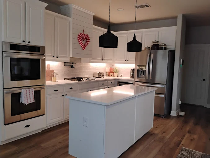 Your Dream Clean owner Kimberly Bryant showing her cleaning worker how to best clean a countertop