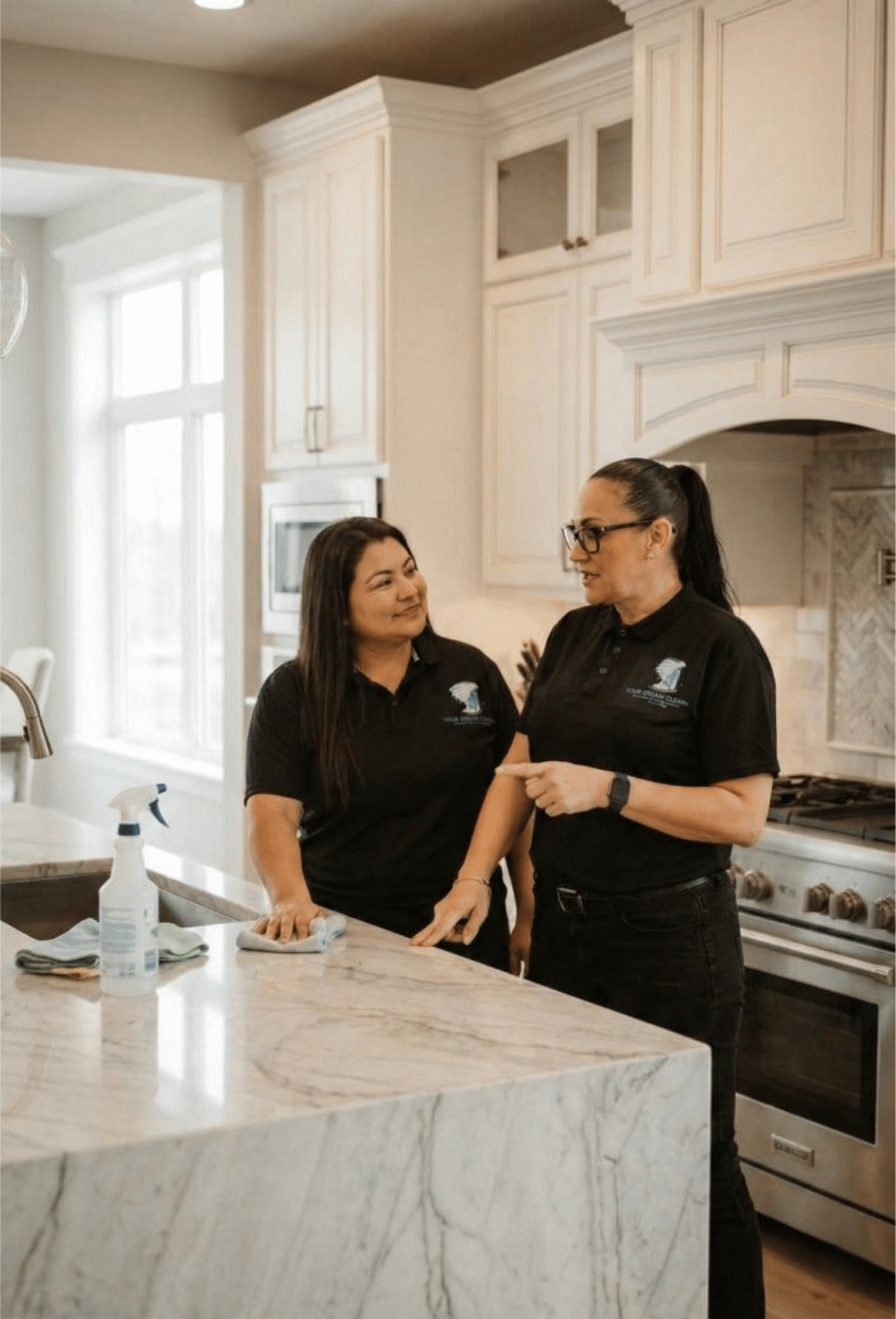 Your Dream Clean owner Kimberly Bryant showing her cleaning worker how to best clean a countertop